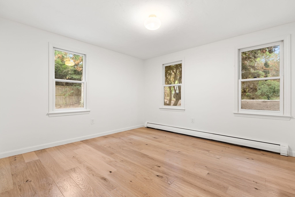 34 Saddleback Road Mashpee, MA 02649 - Photo 10 of 24 a view of an empty room with wooden floor and a window