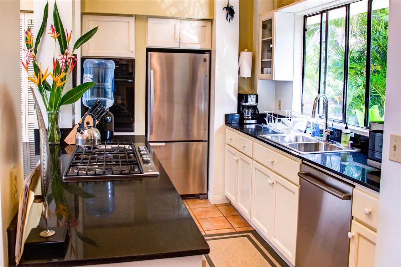311 Door Of Faith Road Haiku, HI 96708 - Photo 14 of 30 a kitchen with stainless steel appliances a refrigerator a stove a sink a counter space and a window