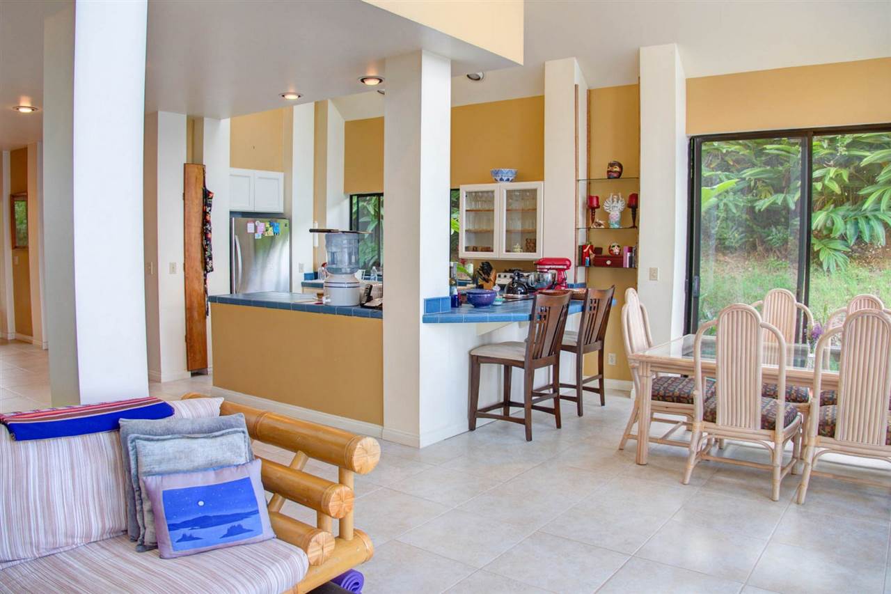 311 Door Of Faith Road Haiku, HI 96708 - Photo 20 of 30 a living room with furniture and a floor to ceiling window