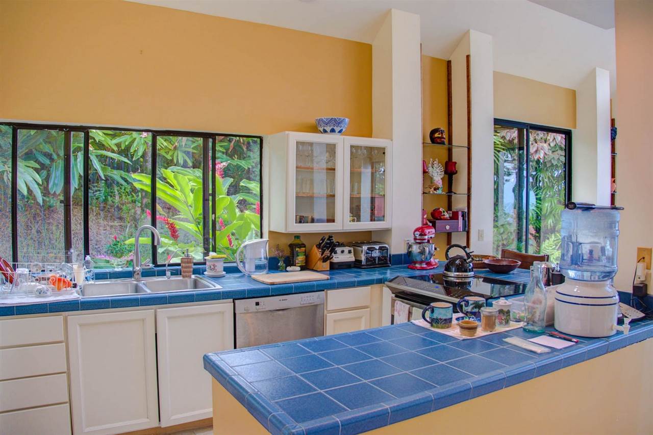 311 Door Of Faith Road Haiku, HI 96708 - Photo 21 of 30 a kitchen with a sink and a large window
