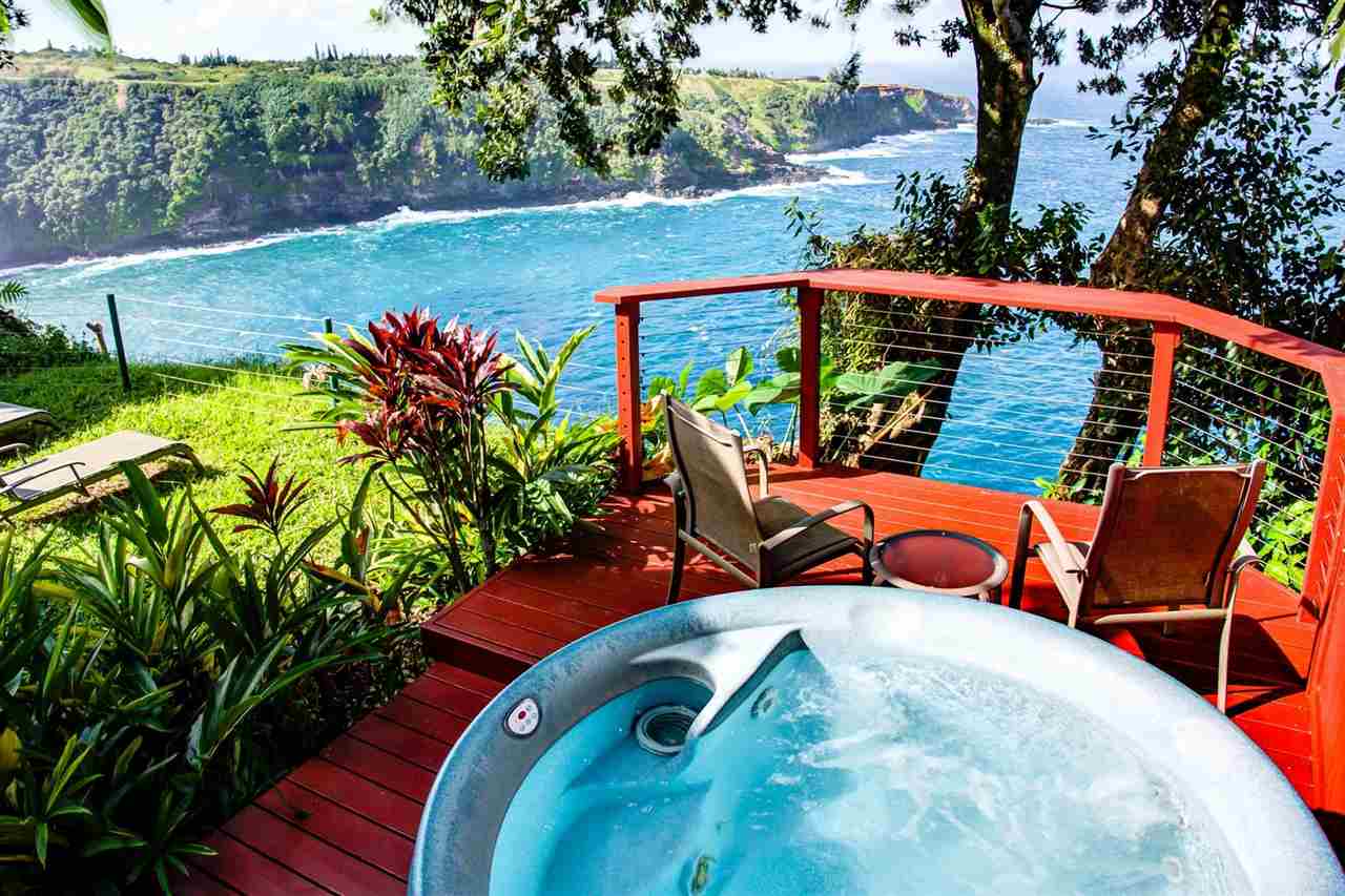 311 Door Of Faith Road Haiku, HI 96708 - Photo 22 of 30 a view of a chairs and table in the patio