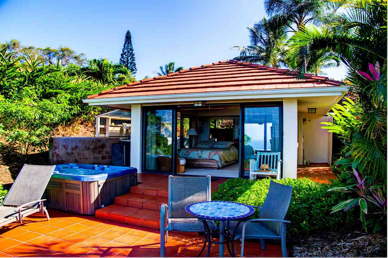 311 Door Of Faith Road Haiku, HI 96708 - Photo 24 of 30 a view of house with a patio and a garden