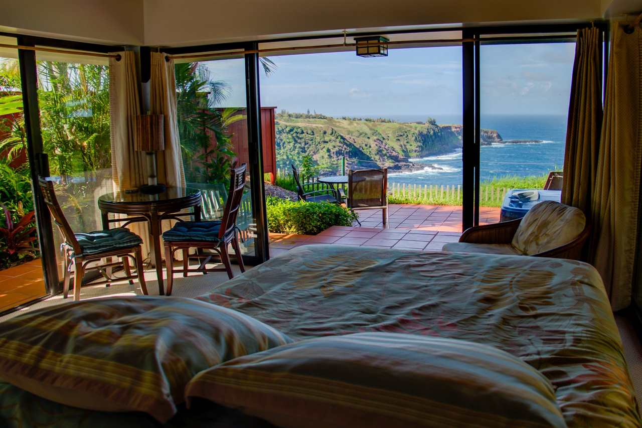 311 Door Of Faith Road Haiku, HI 96708 - Photo 25 of 30 a living room with a bed and a large window