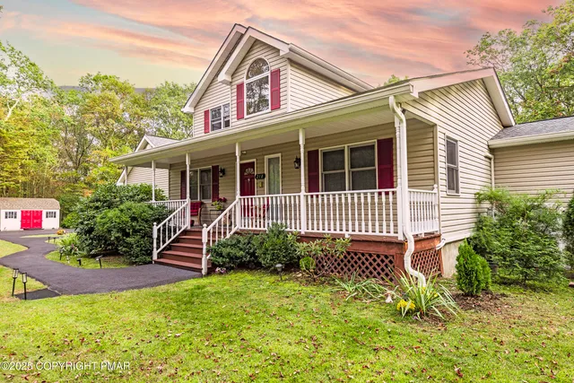 a view of a house with brick walls and a yard with plants