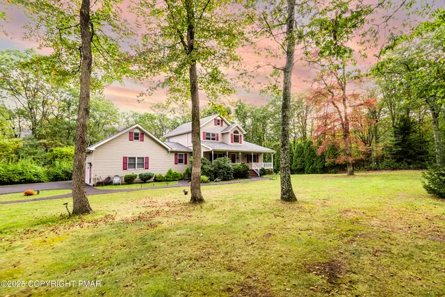 an aerial view of residential house with outdoor space and swimming pool
