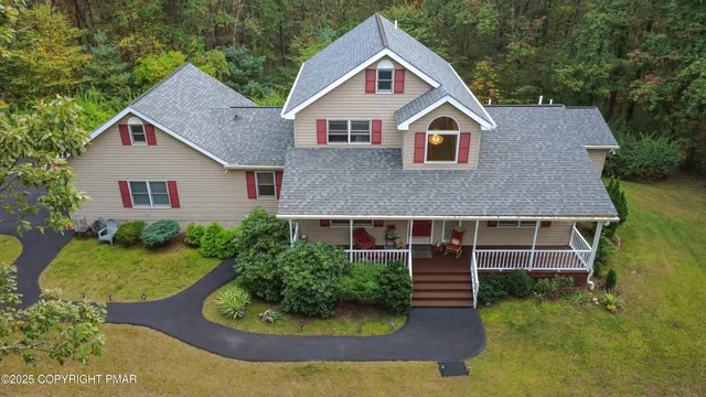 a view of staircase with lots of frames on wall and a window