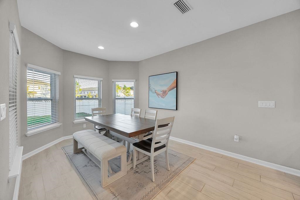 161 Goldcrest Way St. Augustine, FL 32092 - Photo 13 of 52 a dining room with a table and chairs