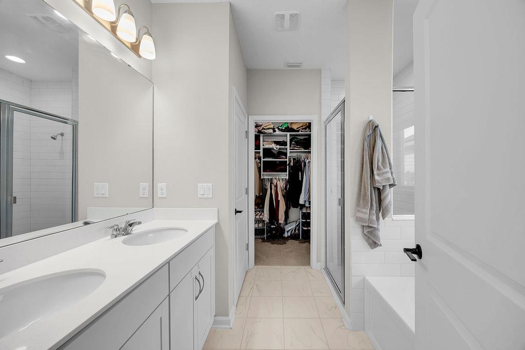 161 Goldcrest Way St. Augustine, FL 32092 - Photo 15 of 52 a spacious bathroom with a double vanity sink and a mirror