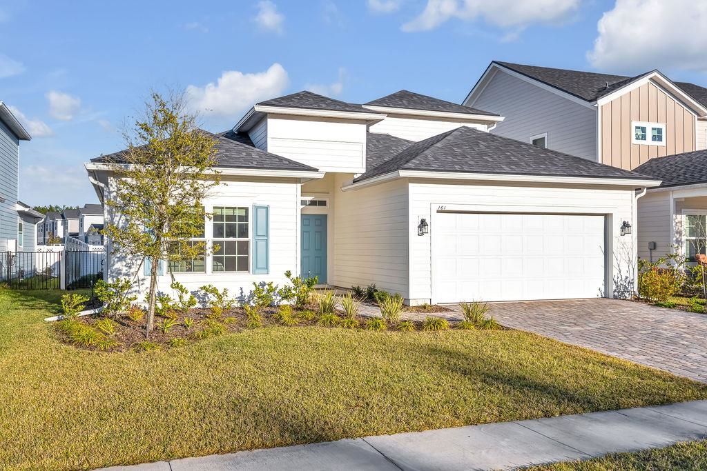 161 Goldcrest Way St. Augustine, FL 32092 - Photo 2 of 52 a front view of a house with a yard