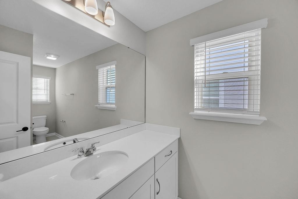 161 Goldcrest Way St. Augustine, FL 32092 - Photo 27 of 52 a bathroom with a sink a mirror and a window
