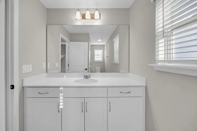 a bathroom with a double vanity sink and a mirror