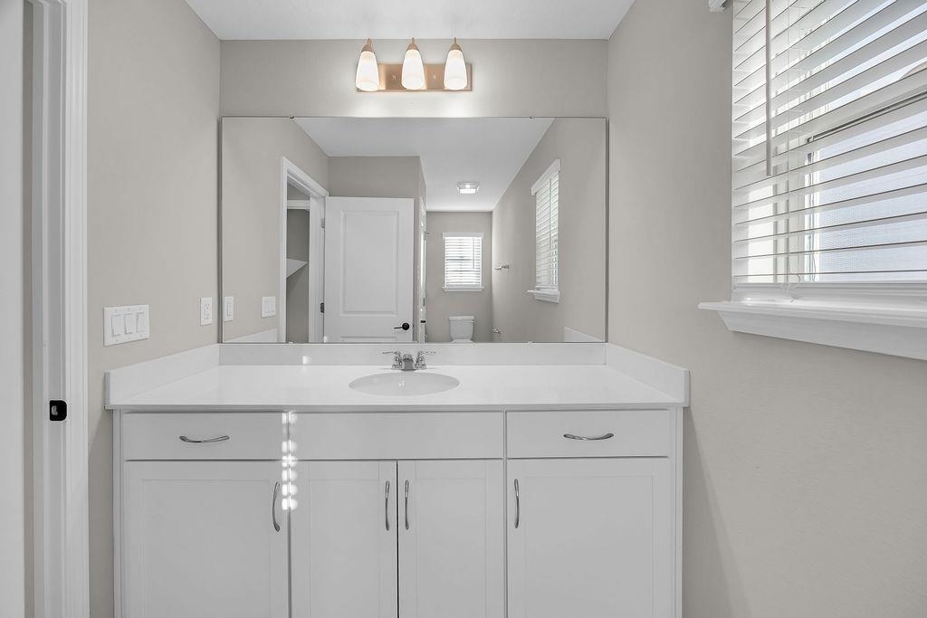 161 Goldcrest Way St. Augustine, FL 32092 - Photo 30 of 52 a bathroom with a double vanity sink and a mirror