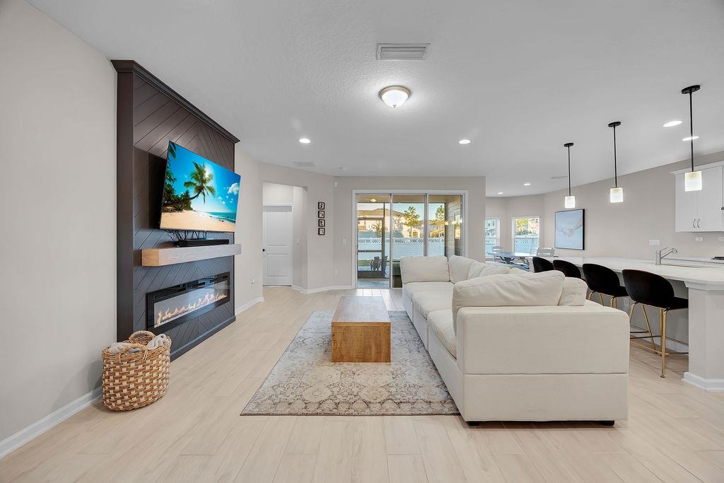 161 Goldcrest Way St. Augustine, FL 32092 - Photo 3 of 52 a living room with furniture and a flat screen tv