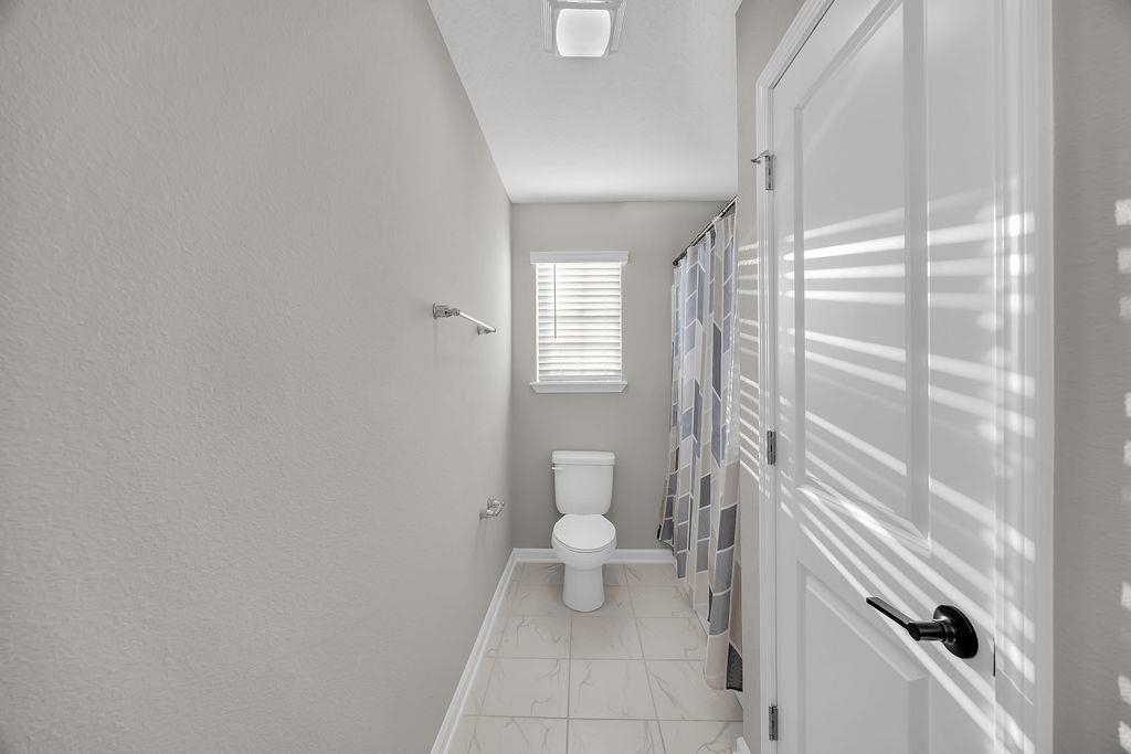 161 Goldcrest Way St. Augustine, FL 32092 - Photo 30 of 52 a bathroom with a toilet and a shower