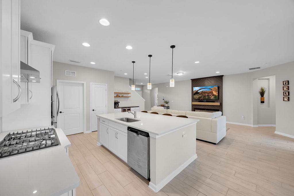 161 Goldcrest Way St. Augustine, FL 32092 - Photo 52 of 52 a kitchen with stainless steel appliances kitchen island a sink a stove a refrigerator and white cabinets