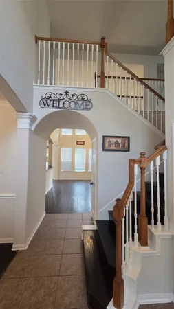 a view of entryway and hall with wooden floor