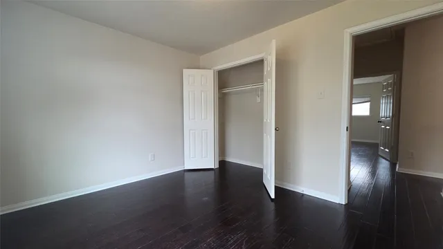 a view of a room with wooden floor