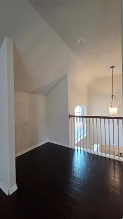 a view of wooden floor and a window in a room