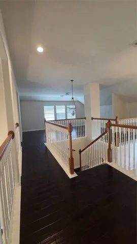 a view of staircase with railing and a rug