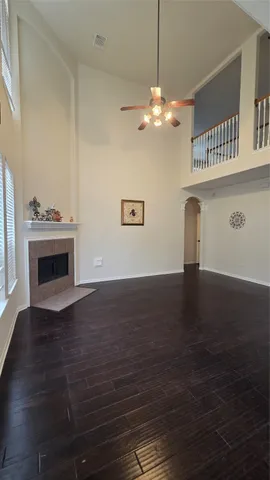 a view of a livingroom with wooden floor and a fireplace