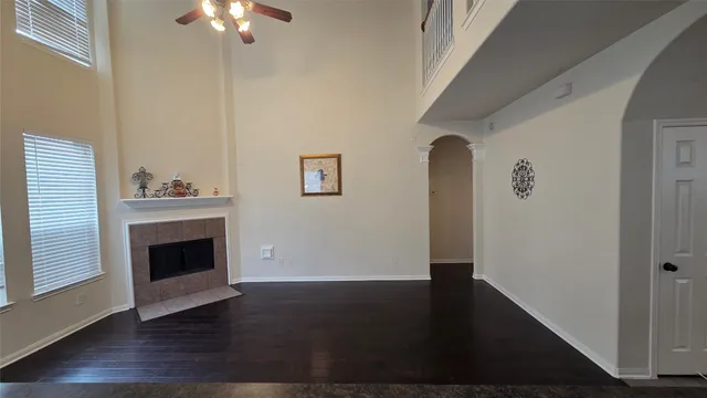 a view of a livingroom with wooden floor a fireplace and window