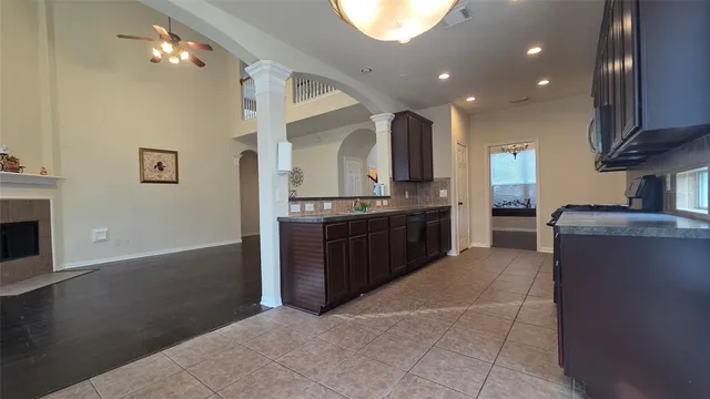 a large kitchen with stainless steel appliances a large counter top a stove and a refrigerator