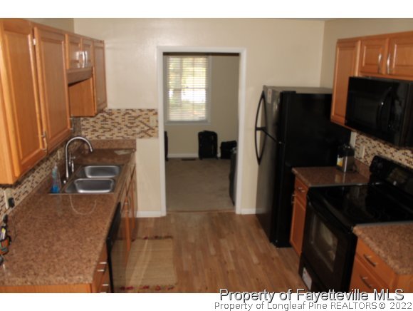 4513 Ruby Road Fayetteville, NC 28311 - Photo 5 of 10 a kitchen with refrigerator and window
