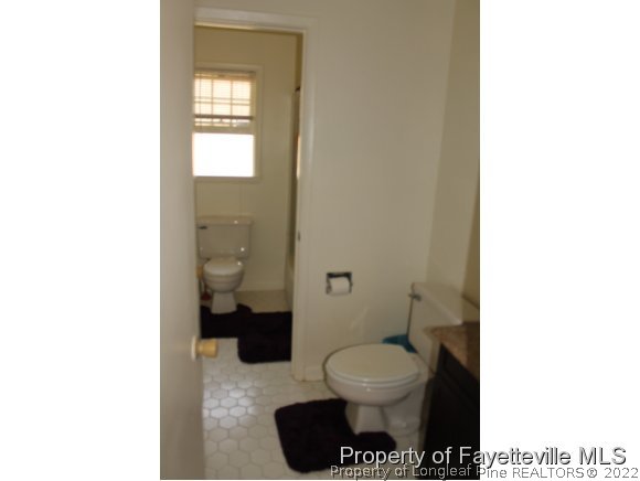 4513 Ruby Road Fayetteville, NC 28311 - Photo 7 of 10 a bathroom with a toilet and a shower