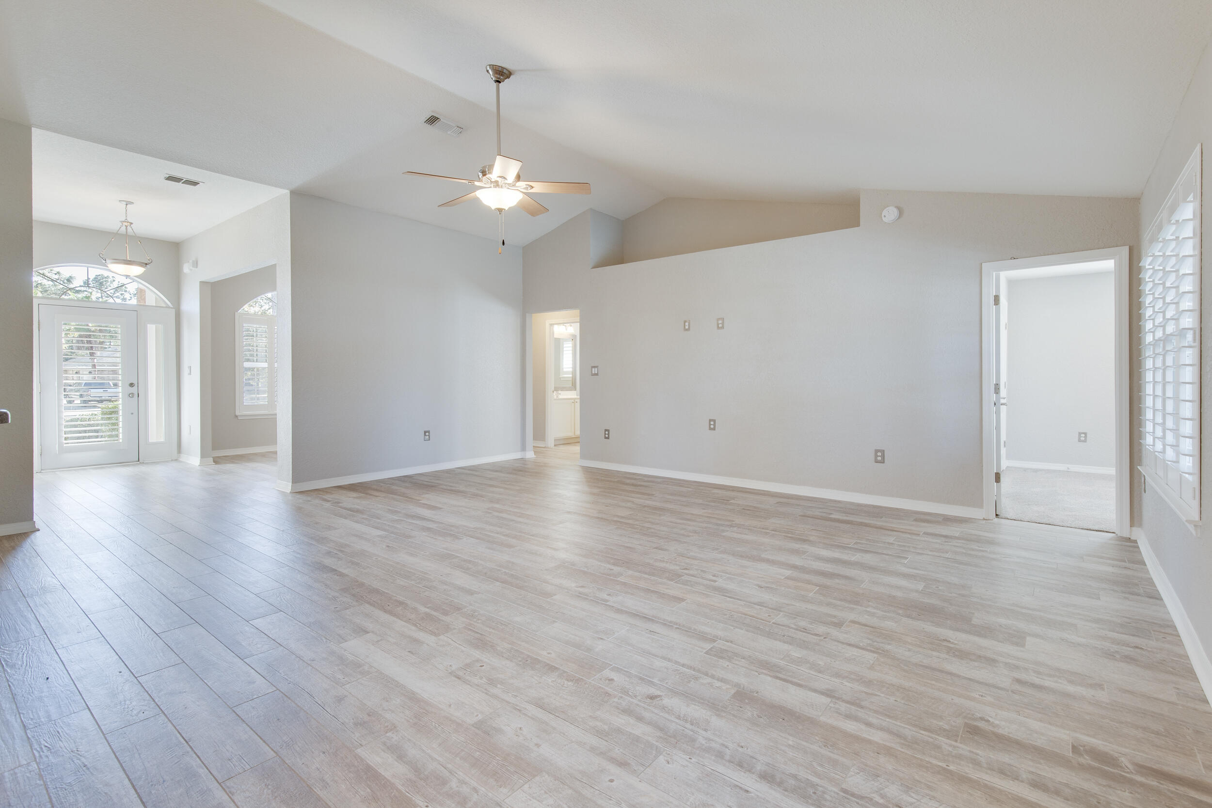 121 East Shipwreck Road Santa Rosa Beach, FL 32459 - Photo 14 of 45 a view of an empty room with wooden floor