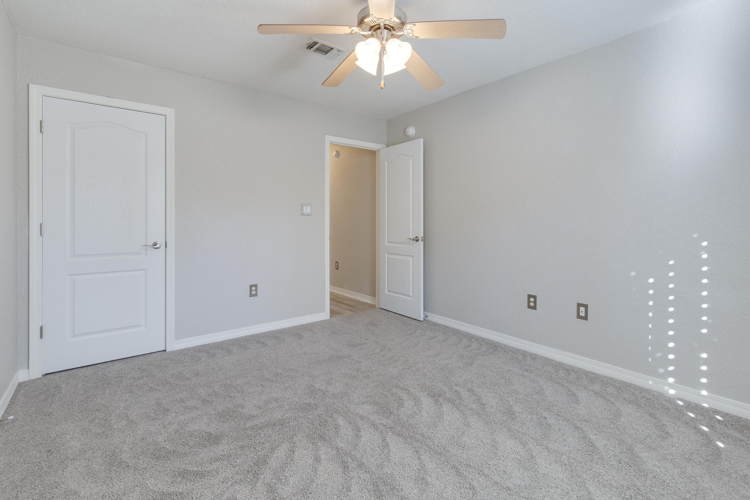 121 East Shipwreck Road Santa Rosa Beach, FL 32459 - Photo 22 of 45 an empty room with chandelier fan and windows