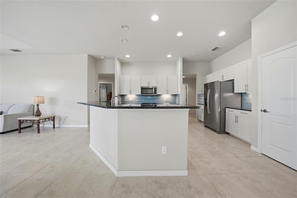5455 Graves Terrace Port Charlotte, FL 33981 - Photo 15 of 54 a kitchen with refrigerator and chairs