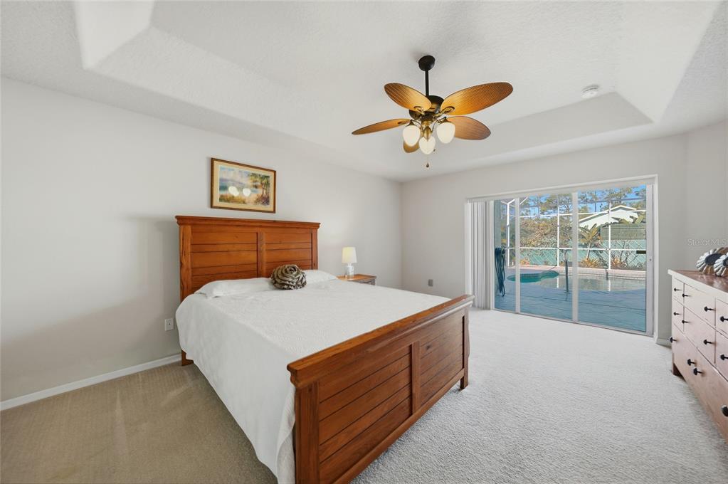 5455 Graves Terrace Port Charlotte, FL 33981 - Photo 19 of 54 a bed room with a bed and a ceiling fan