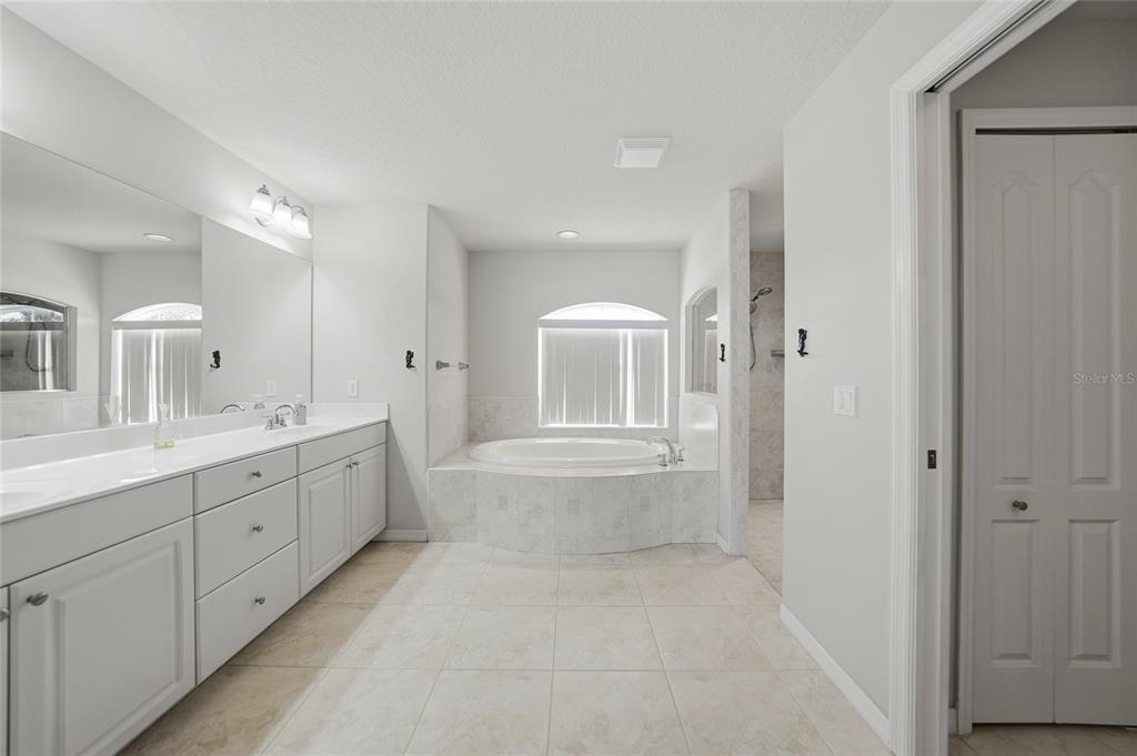 5455 Graves Terrace Port Charlotte, FL 33981 - Photo 24 of 54 a bathroom with a double vanity sink a mirror and a bathtub