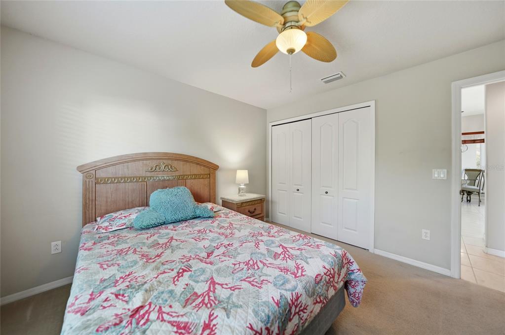 5455 Graves Terrace Port Charlotte, FL 33981 - Photo 26 of 54 a bedroom with a bed and a chandelier