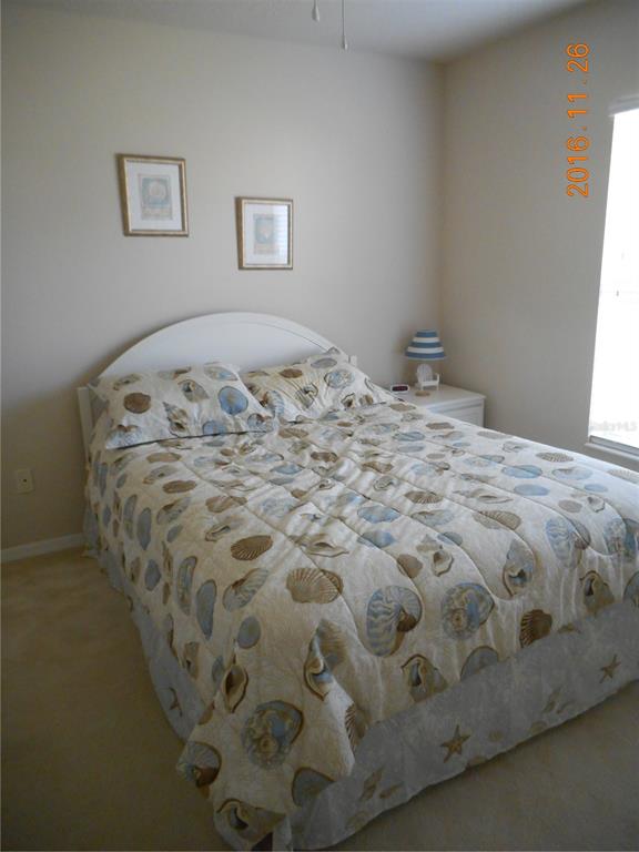 5455 Graves Terrace Port Charlotte, FL 33981 - Photo 31 of 54 a bed sitting in a bedroom next to a window