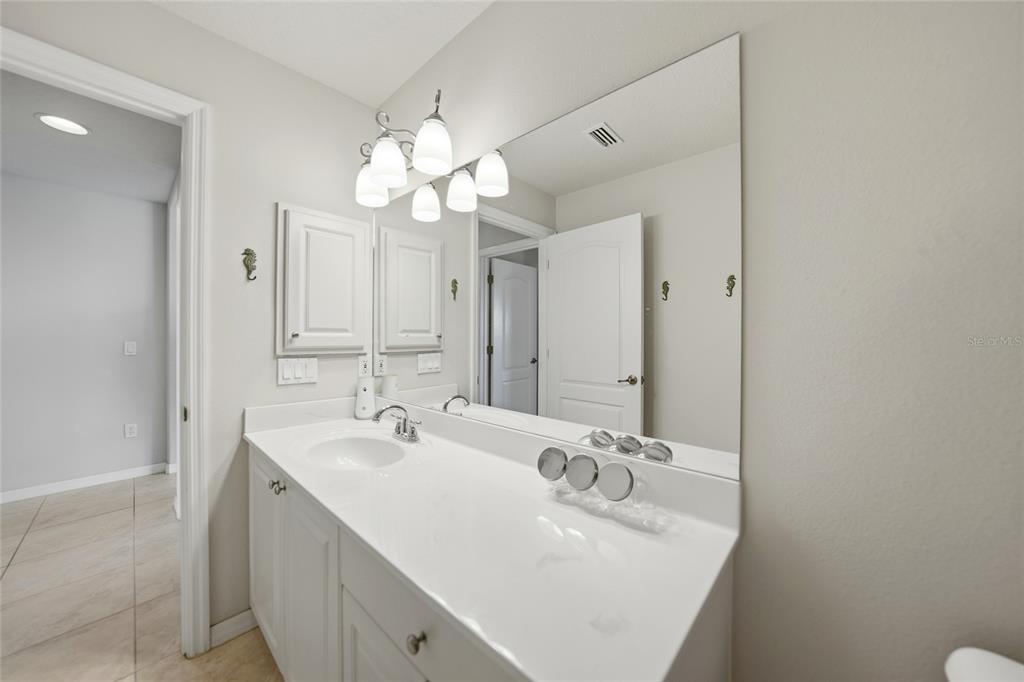 5455 Graves Terrace Port Charlotte, FL 33981 - Photo 32 of 54 a bathroom with a sink a mirror and a light fixture