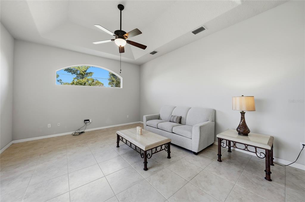 5455 Graves Terrace Port Charlotte, FL 33981 - Photo 35 of 54 a living room with furniture and a chandelier