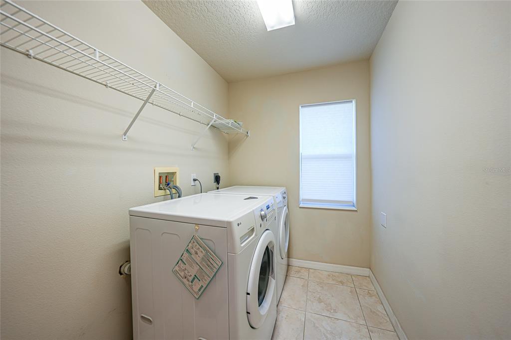 5455 Graves Terrace Port Charlotte, FL 33981 - Photo 37 of 54 a utility room with dryer and washer