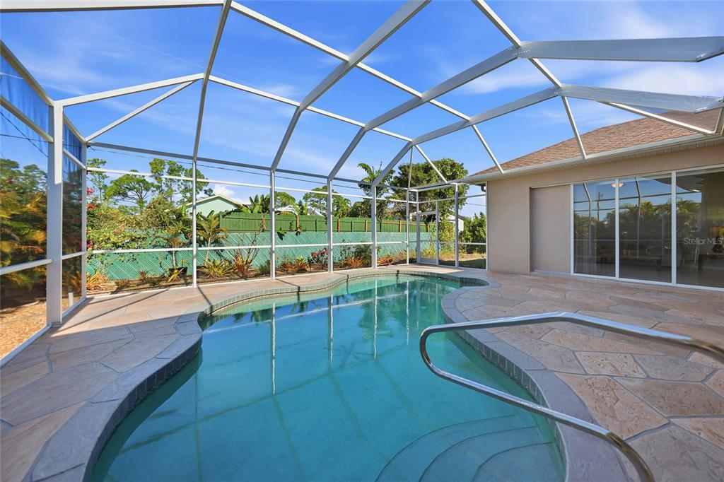 5455 Graves Terrace Port Charlotte, FL 33981 - Photo 40 of 54 a view of a patio with a table and chairs under an umbrella