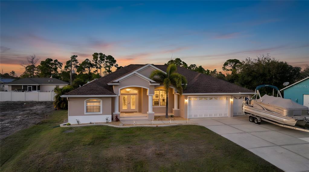 5455 Graves Terrace Port Charlotte, FL 33981 - Photo 50 of 54 a front view of a house with a yard