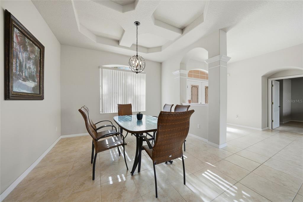 5455 Graves Terrace Port Charlotte, FL 33981 - Photo 10 of 54 a view of a dining room with furniture and a chandelier