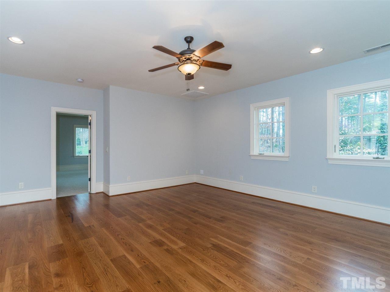 605 Queensferry Road Cary, NC 27511 - Photo 14 of 25 a view of an empty room with wooden floor and a window