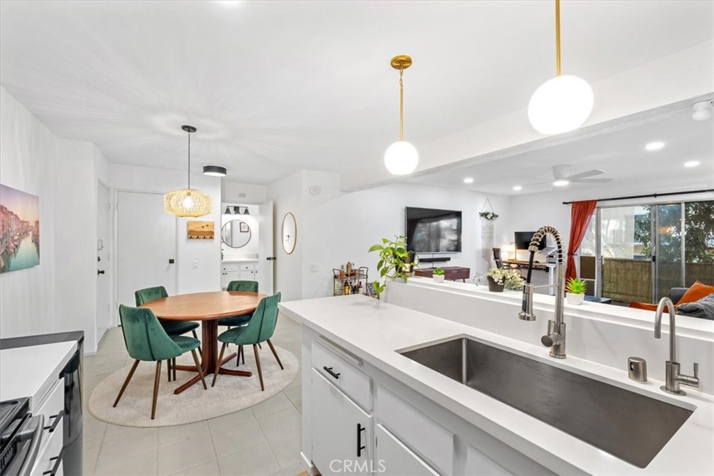 a kitchen with a sink a counter and chairs