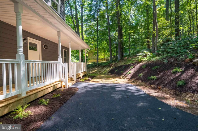 a view of a porch with wooden floor in front of house