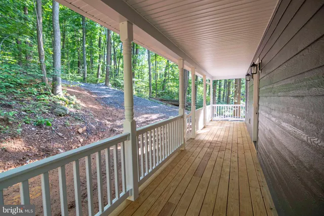a kitchen with a refrigerator a sink and a stove top oven with wooden floor