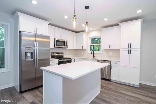 a view of deck and a yard with wooden fence