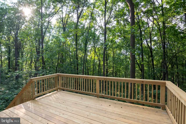 a view of balcony with wooden floor and fence