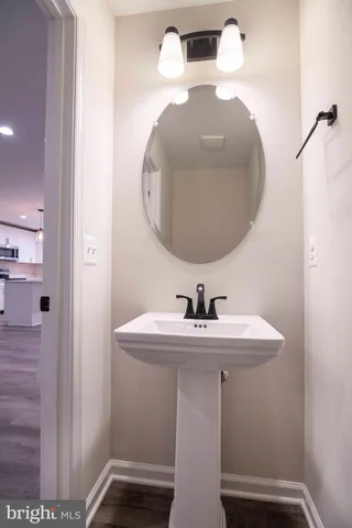 a bathroom with a double vanity sink a mirror and a bathtub