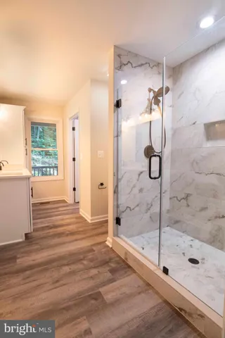 a bedroom with a bed a couch and a window