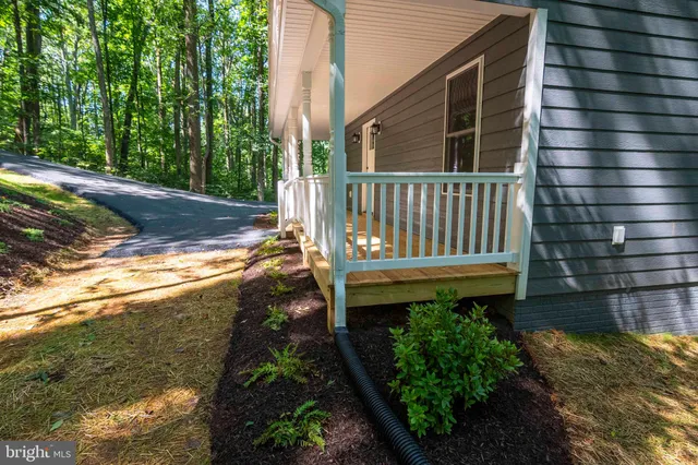 a front view of a house with a yard and balcony
